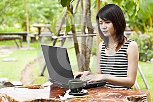 Beautiful Asian woman using computer notebook.