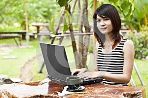 Beautiful Asian woman using computer notebook.