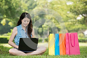 Beautiful asian woman using computer shopping online