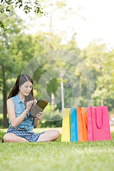 Beautiful asian woman using digital tablet shopping online