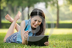 Beautiful asian woman using digital tablet shopping online