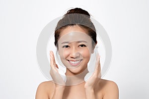 Beautiful Asian woman is using a facial foam to wash cosmetics off her face