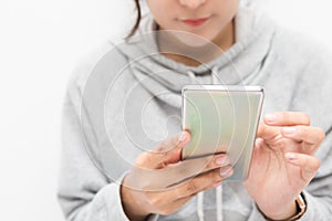 Beautiful Asian woman wearing grey casual shirt holding smartphone on white background and copy space.  Cute Asian woman is