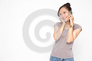 Beautiful Asian woman wearing grey casual shirt holding smartphone on white background and copy space.  Cute Asian woman smiling