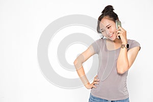 Beautiful Asian woman wearing grey casual shirt holding smartphone on white background and copy space.  Cute Asian woman smiling