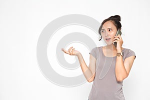 Beautiful Asian woman wearing grey casual shirt holding smartphone on white background and copy space.  Cute Asian woman stressed