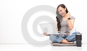 Beautiful Asian woman wearing grey casual shirt using laptop on white background and copy space. Cute Asian woman sitting on the