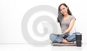 Beautiful Asian woman wearing grey casual shirt using laptop on white background and copy space.  Cute Asian woman sitting on the