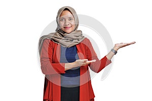 Beautiful Asian woman wearing hijab presenting blank area copy space