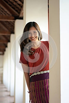 Beautiful Asian woman by wearing sarong looking at camera on the blurred background