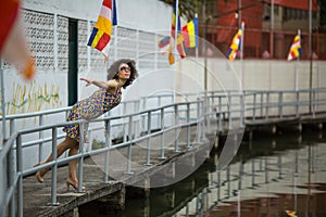 Beautiful asian woman wearing sunglasses on the river embankment.