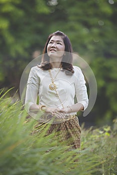 Beautiful asian woman wearing thai period traditon clothes stand