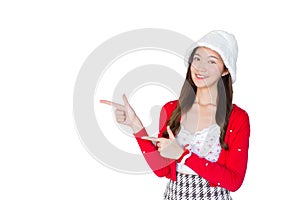Beautiful Asian woman who wears red coat and white hat as santy girl acts her hand to present something while isolated on white