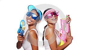 Beautiful Asian women in pink and blue sun visor cap and sunglasses posing with water guns over white background