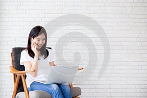 Beautiful asian young businesswoman excited and glad of success with laptop, girl taking mobile phone and working