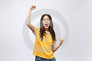 Beautiful asian young woman excited and glad of success , isolated over grey background, career freelance business