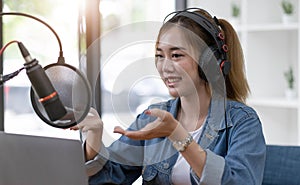 Beautiful asian young woman radio host working, setting microphone, preparing to speak before recording podcast and live on social