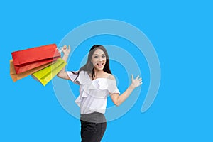 Beautiful asian young woman with shopping bags with smile while standing at the clothing store. Happiness, consumerism, sale and