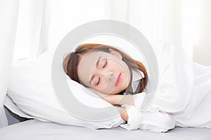 Beautiful asian young woman sleeping lying in bed on bedroom with head on pillow comfortable and happy