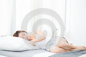 Beautiful asian young woman sleeping lying in bed with head on pillow comfortable and happy.