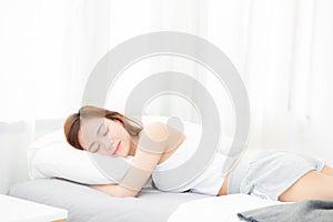 Beautiful asian young woman sleeping lying in bed with head on pillow comfortable and happy