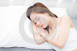 Beautiful asian young woman sleeping lying in bed with head on pillow comfortable and happy.