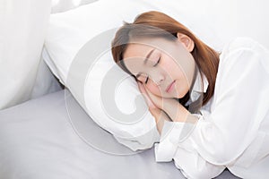 Beautiful asian young woman sleeping lying in bed with head on pillow comfortable and happy.