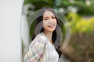 Beautiful asian young woman smile and cheerful. Confident cute female looking at camera relax and happiness with wellness life.