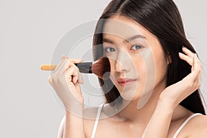 Beautiful Asian young woman smile and holding make up brush
