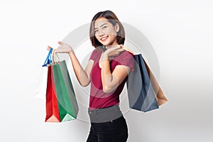 Beautiful asian young woman smiling holding shopping bags isolated on white background