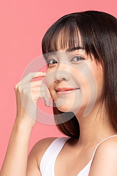 Beautiful Asian young woman touching soft cheek smile with clean fresh skin