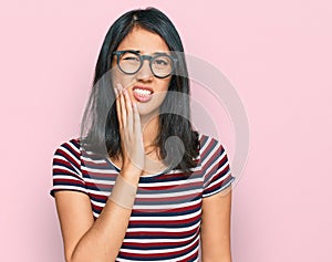 Beautiful asian young woman wearing casual clothes and glasses touching mouth with hand with painful expression because of