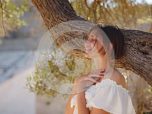 Beautiful Asian young woman in white dress outdoor