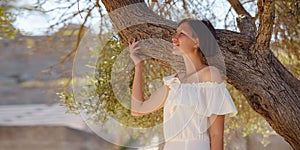 Beautiful Asian young woman in white dress outdoor