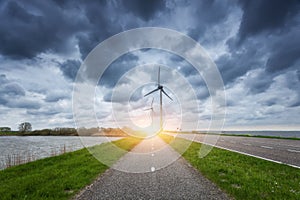 Beautiful asphalt road with wind turbines