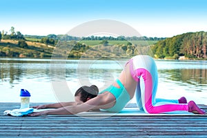 Beautiful athletic girl doing yoga against the backdrop of beautiful nature, pose asana Balasana. The concept of a healthy