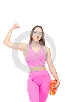 A beautiful, athletic, slim, smiling and cheerful woman in a pink tracksuit in a comic uniform demonstrates the muscles
