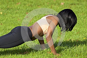 Beautiful athletic woman doing push ups exercise