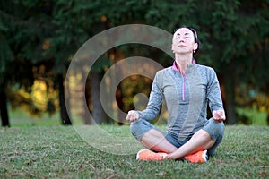 Beautiful athletic woman making yoga. Relax in nature.