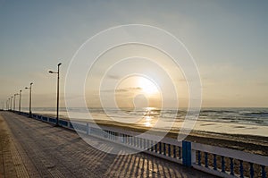 Beautiful Atlantic beach promenade with stone walkway during sunset at Sidi Ifni, Morocco, North Africa