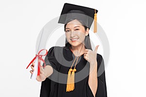 Beautiful Attractive Asian woman graduated in cap and gown smile with certificated in her hand feeling so proud and happiness,