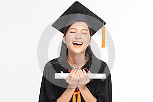 Beautiful Attractive Asian woman graduated in cap and gown smile with certificated in her hand feeling so proud and happiness,