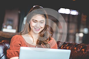 Beautiful Attractive Asian woman working with computer laptop and thinking to get ideas and requirement in Business startup
