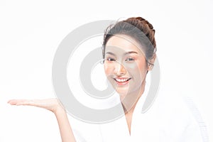 Beautiful Attractive Charming Asian young woman smile with white teeth open hand palm for display cosmetics product cheerful with