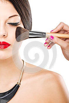 Beautiful attractive woman with half face, luxury makeup brush of his face