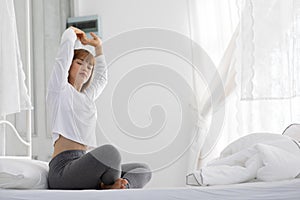 Beautiful Attractive Woman stretching her arm after wake up on bed