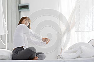 Beautiful Attractive Woman stretching her arm after wake up on bed feeling so fresh and relax in the morning