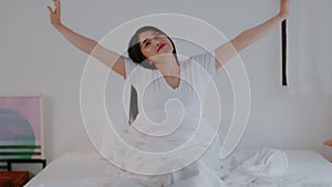 Beautiful Attractive Woman stretching her arm after wake up on bed feeling so fresh and relax in the morning,Healthcare Concept