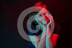 Beautiful attractive young woman posing in neon light in studio