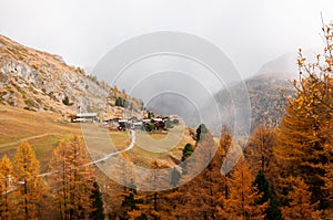 Beautiful autumn alpine landscape with many old chalets in Zermatt area